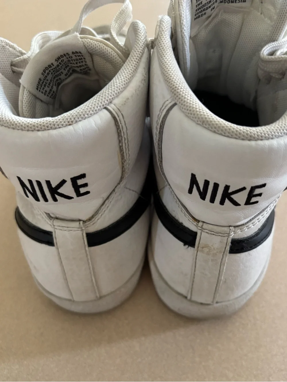 Nike Women’s White and Black High-Top Sneakers with Iconic Swoosh